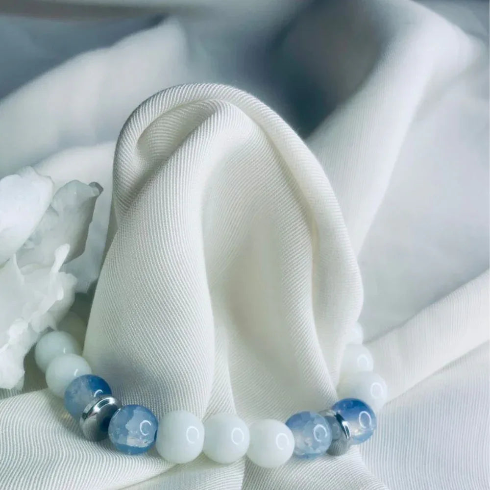 Bracelet with blue lace agate, white howlite beads, and silver spacer beads in a stretch design.