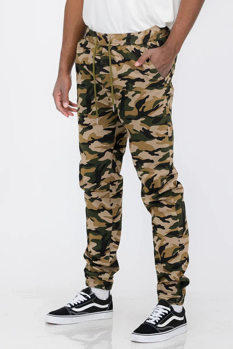 Close-up of elastic waistband and front pockets on solid color jogger pants.