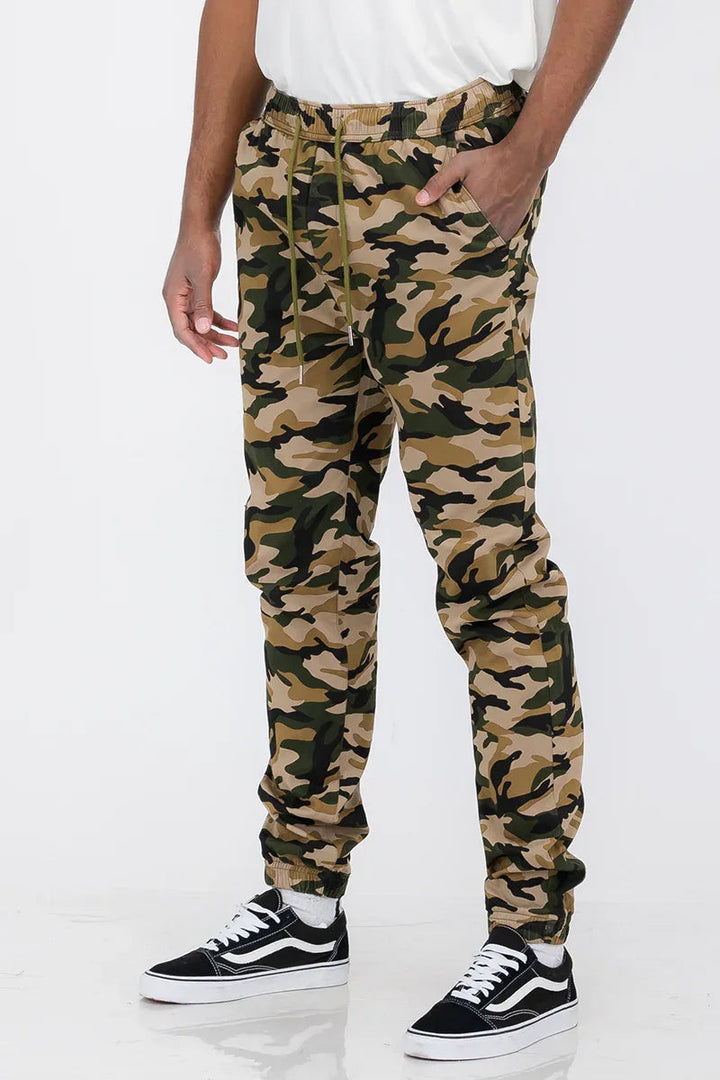 Close-up of elastic waistband and front pockets on solid color jogger pants.