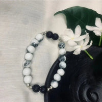 Howlite and Black Onyx beaded bracelet with silver spacers displayed on a neutral background.