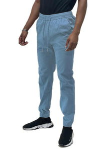 Front view of solid jogger pants with elastic waistband and pockets laid flat on a white surface.