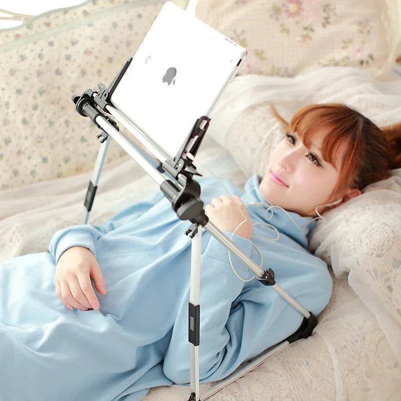 Foldable bed holder supporting a tablet and phone, angled for comfortable viewing