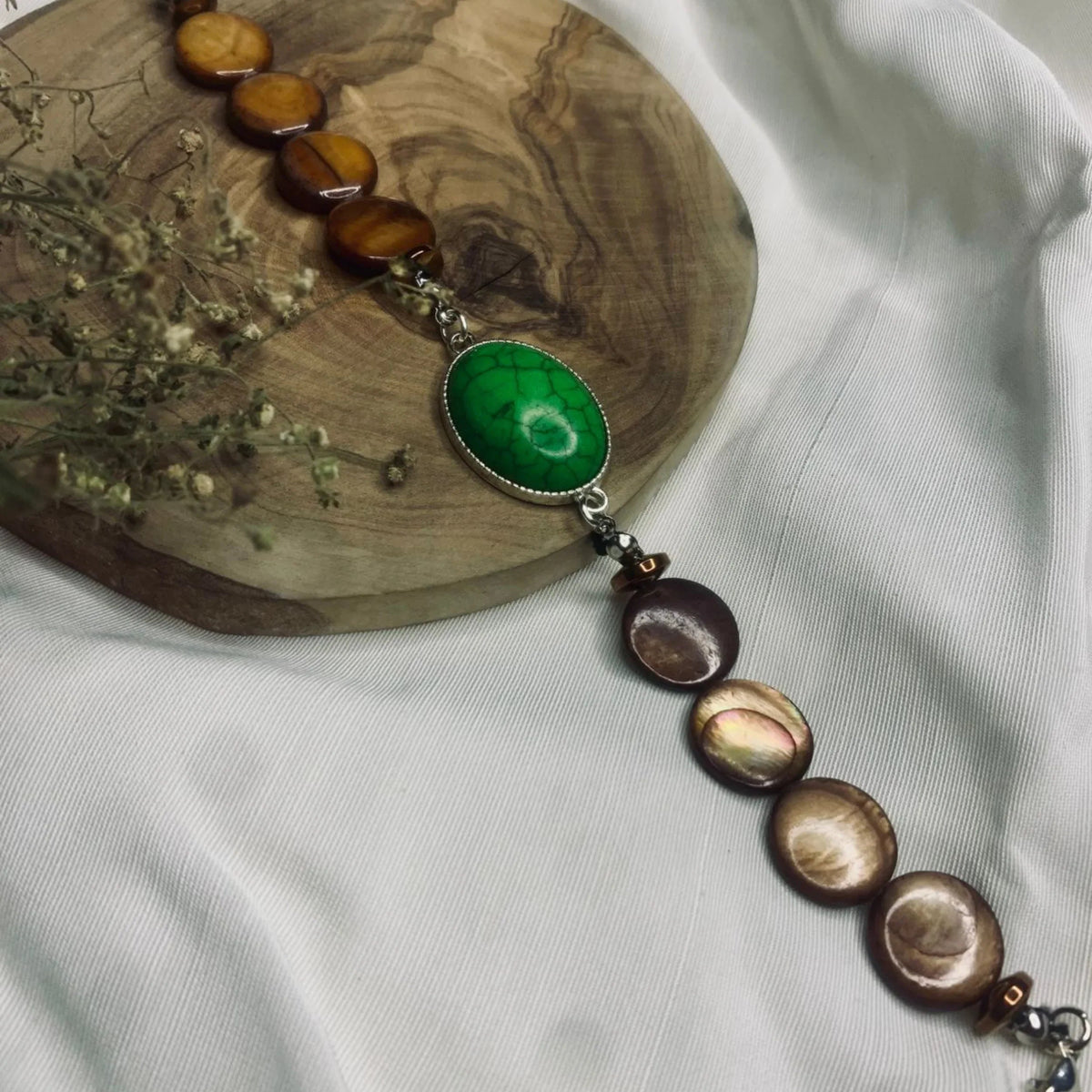 Side angle of boho chic bracelet highlighting metal links and earthy bead colors.