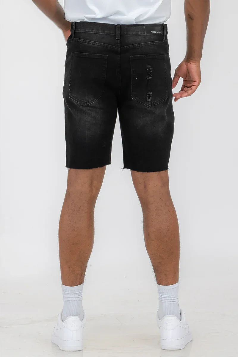 Rear view of men's distressed denim shorts highlighting back pockets and distressed details.
