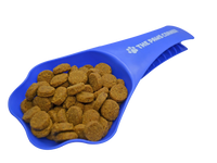 Paw-shaped green pet food scoop with handle and clip, holding 1 cup of dry kibble on a white background.