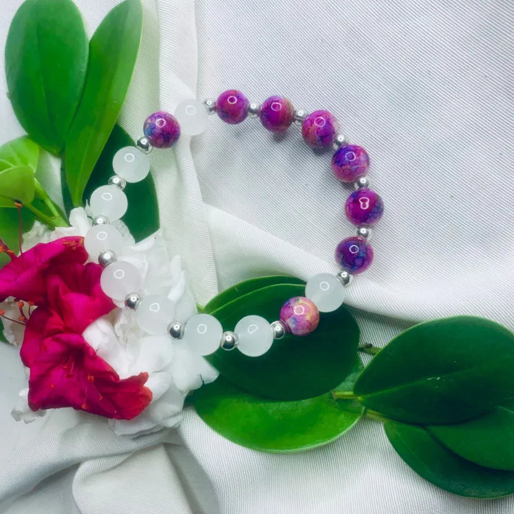 Elegant bracelet featuring alternating white and purple stones with shiny silver spacers.