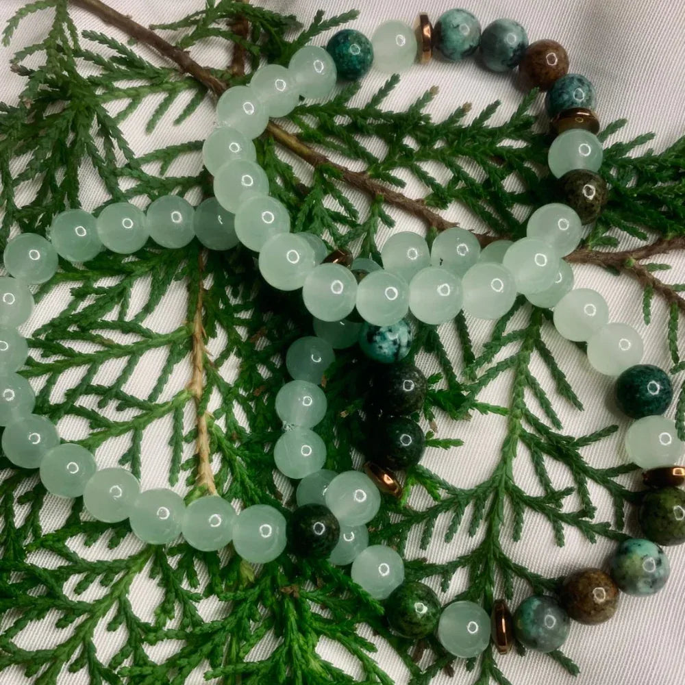 Elegant green and white agate bracelet featuring copper spacer beads against plain backdrop
