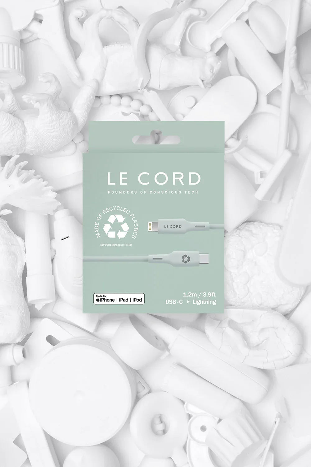 Close-up of recycled TPE connector shell and cable sleeve with natural pale pine color in recyclable packaging.