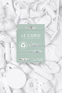 Close-up of recycled TPE connector shell and cable sleeve with natural pale pine color in recyclable packaging.