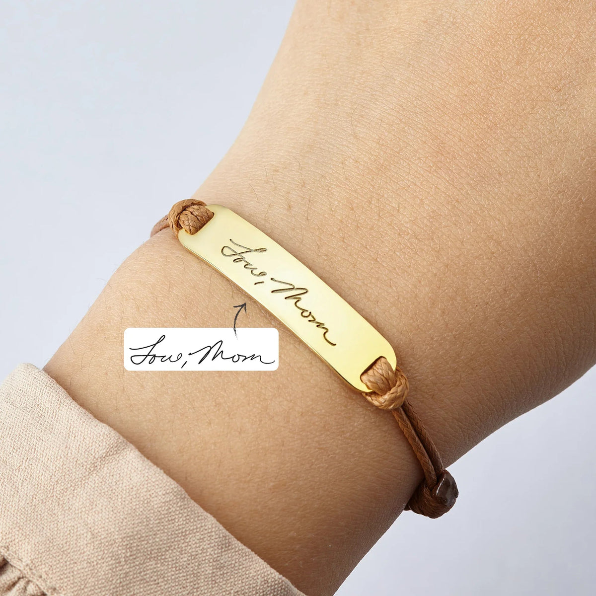 Personalized handwriting bracelet shown with chain and engraved message.