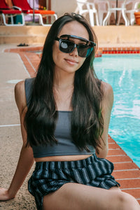 Flipside Sunglasses folded flat showing frame thickness and visor mechanism.