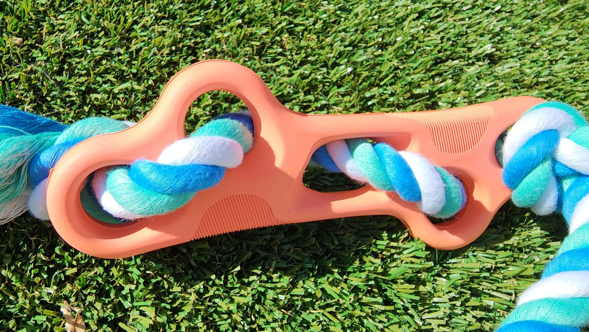 Close-up of high-quality natural rubber dog bone chew toy with durable tug rope.