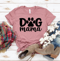 Front view of white Dog Mama T-shirt with black lettering, laid flat on a neutral background.