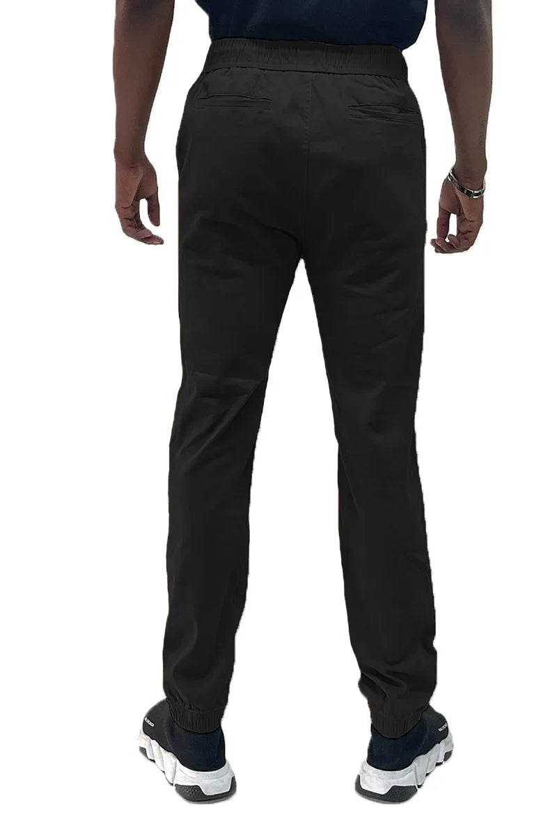 Back view of black jogger pants highlighting two back pockets and elastic ankle cuffs.