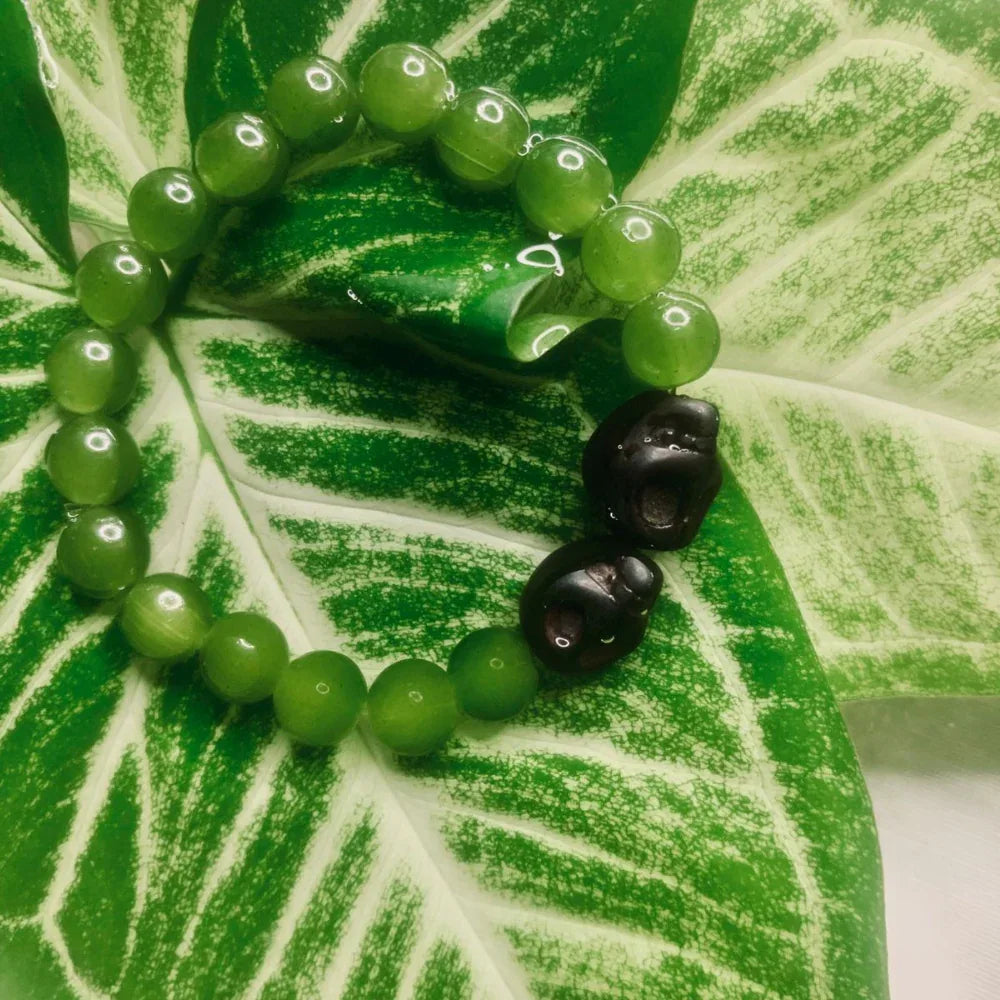 Natural stone bead bracelet displayed on white background, highlighting round gemstone beads.