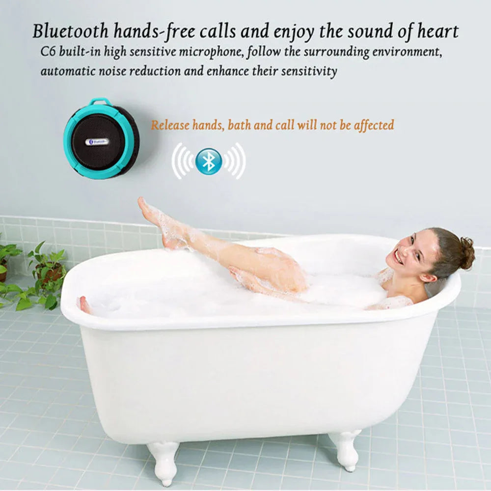 Mini portable waterproof Bluetooth speaker shown hanging from backpack strap using metal hook