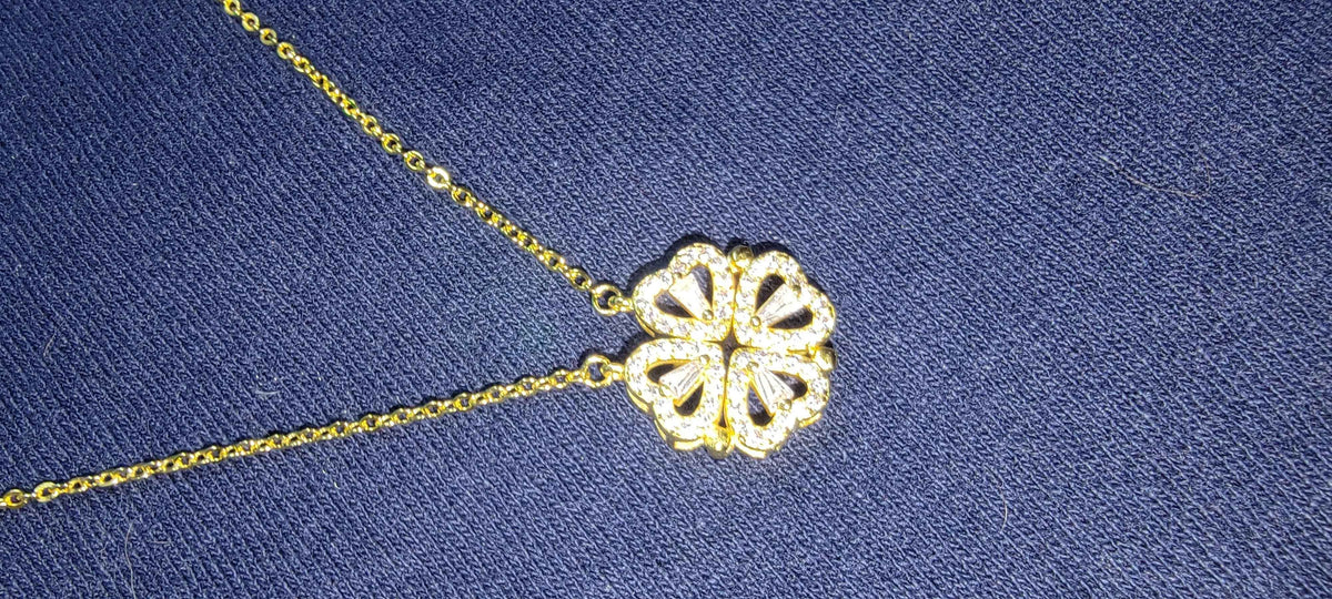 Detailed close-up of the four-leaf clover and heart shape necklace pendant with high gloss polish.
