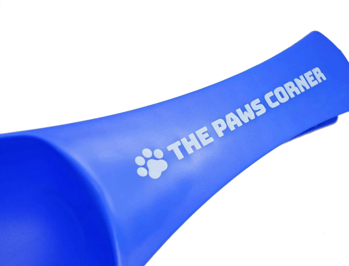 Paw-shaped pet food scoop with built-in clip, holding one cup, made of sturdy, durable plastic.