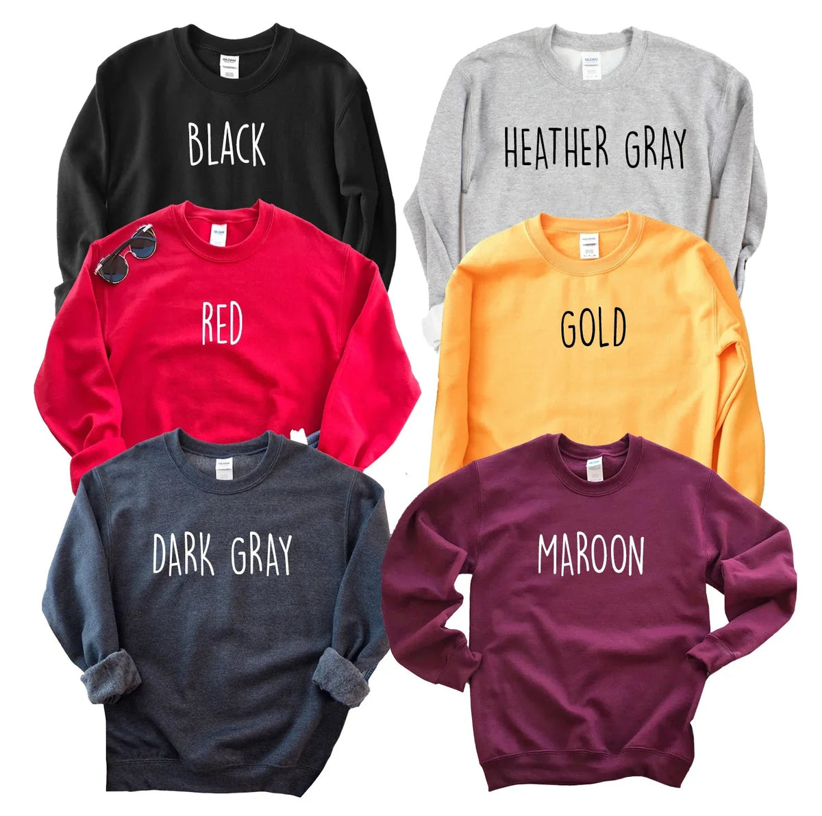 Full view of folded gray crew neck sweatshirt showcasing fabric and construction details