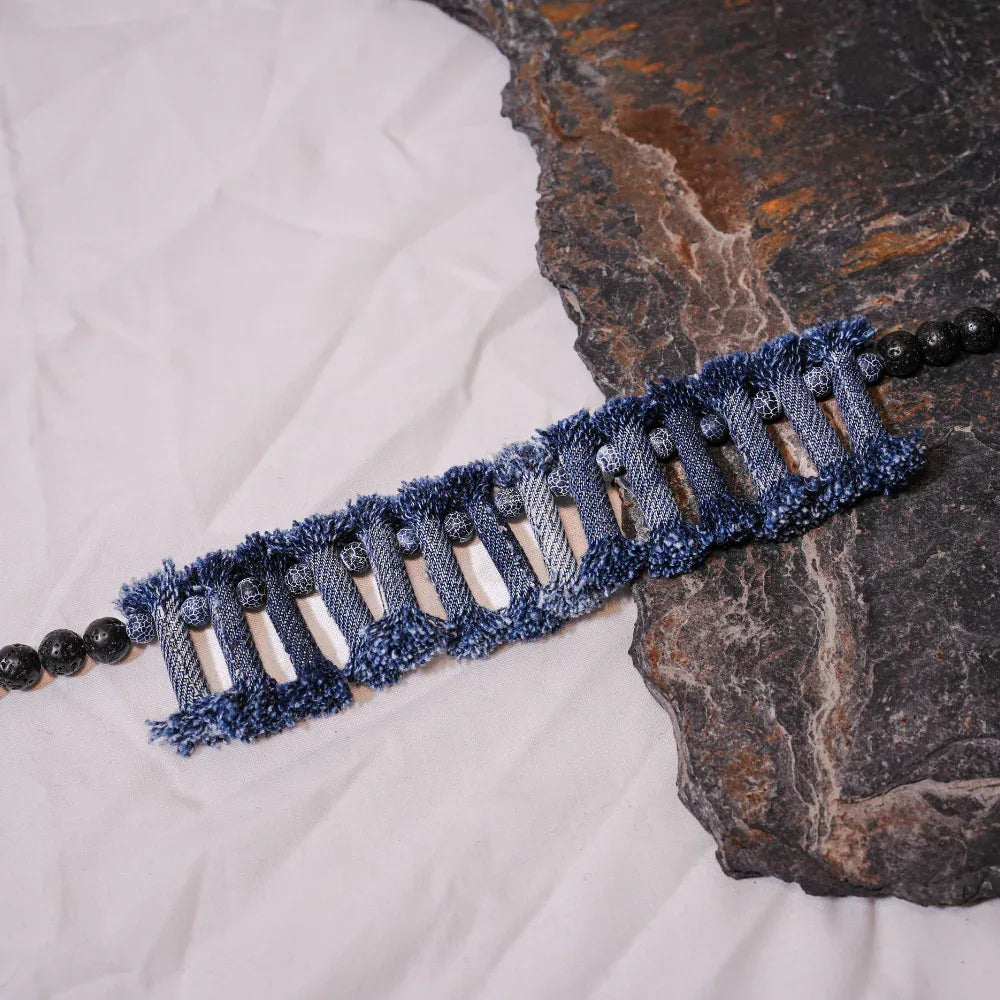 Denim necklace and bracelet set arranged on white background showcasing tribal design and natural stones.