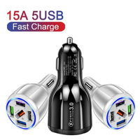 Black car charger with five USB ports plugged into a car, charging several devices at once.