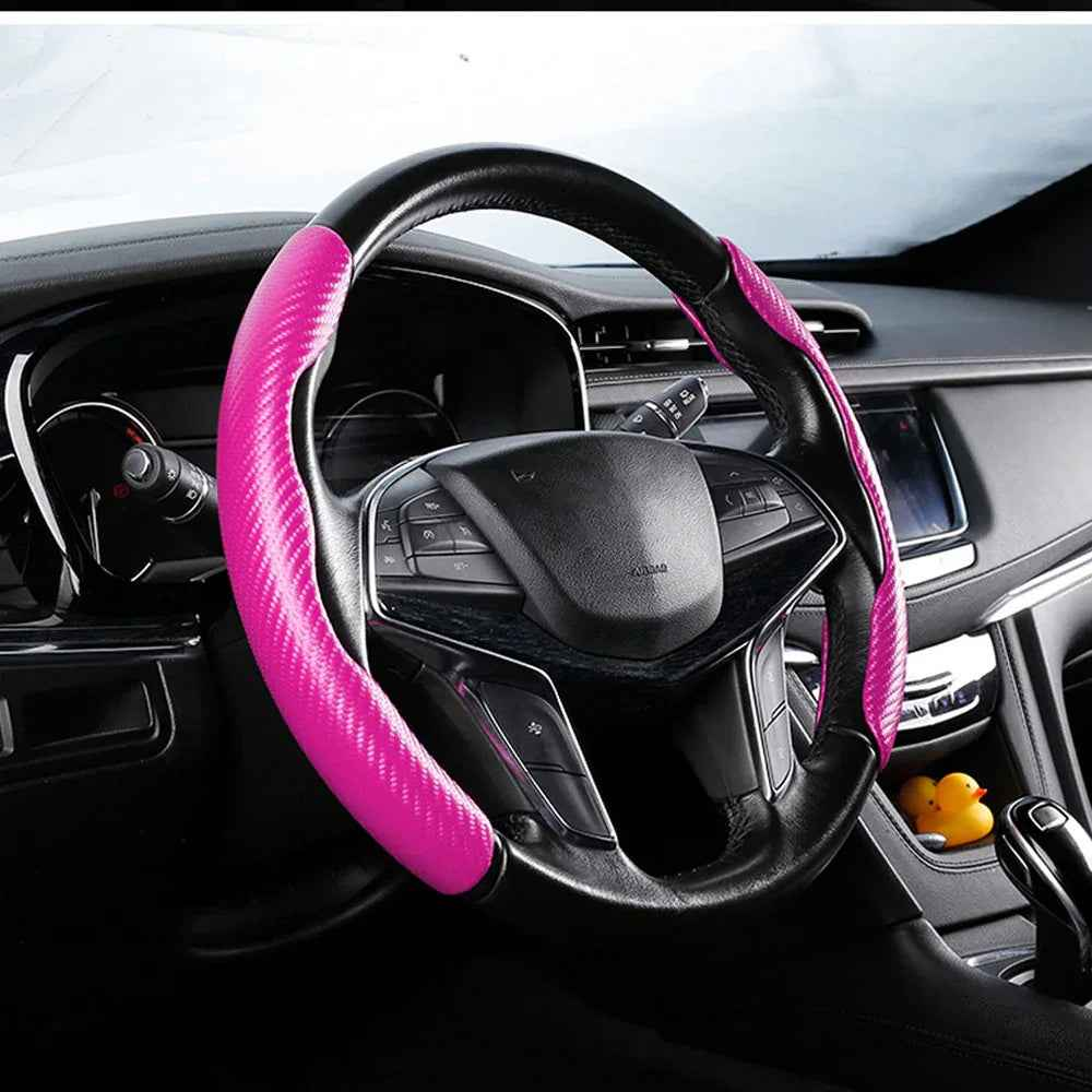 Black carbon fiber textured steering wheel covers installed on a car, shown close up inside the driver's seat.