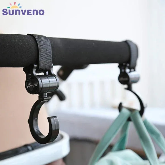 Side view of maroon stroller hook demonstrating 360 degree swivel and strap attachment