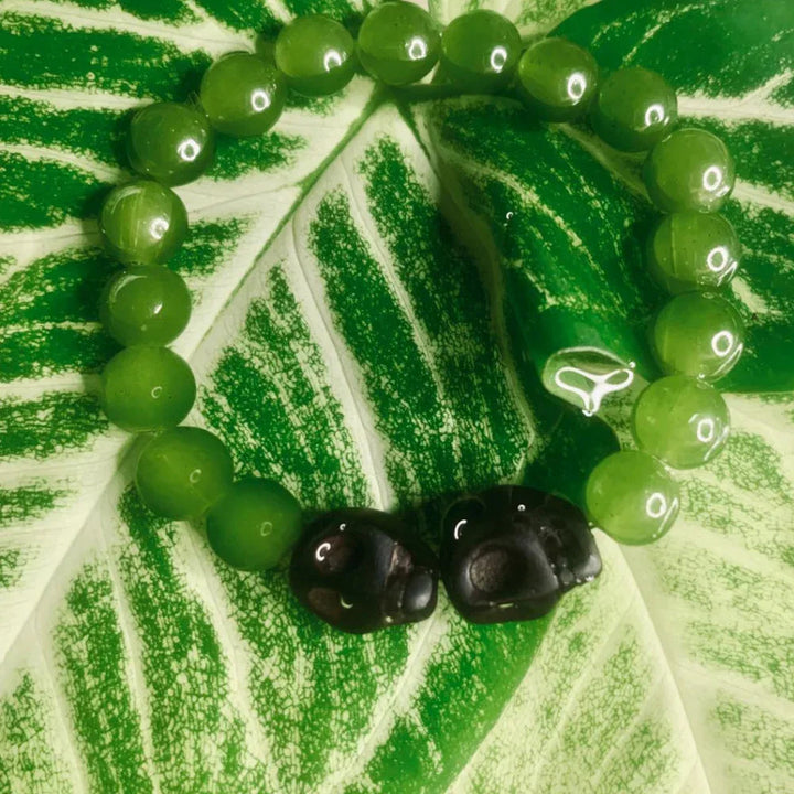 Close-up of boho style natural stone bead bracelet with mixed gemstone colors on elastic band.