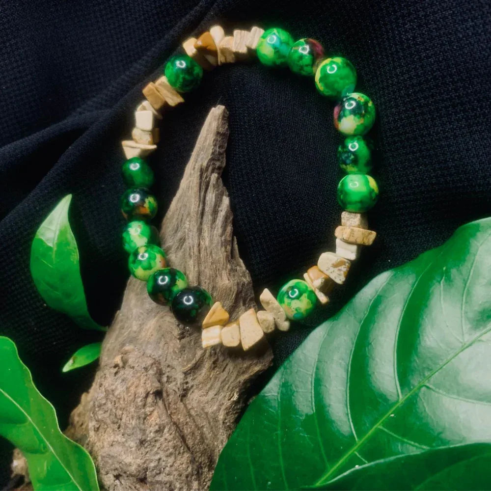Close-up of rugged earth tone chips and smooth dark beads creating an organic bracelet.