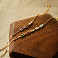Elegant display of a birthstone mom bracelet with multicolored charms and delicate chain.