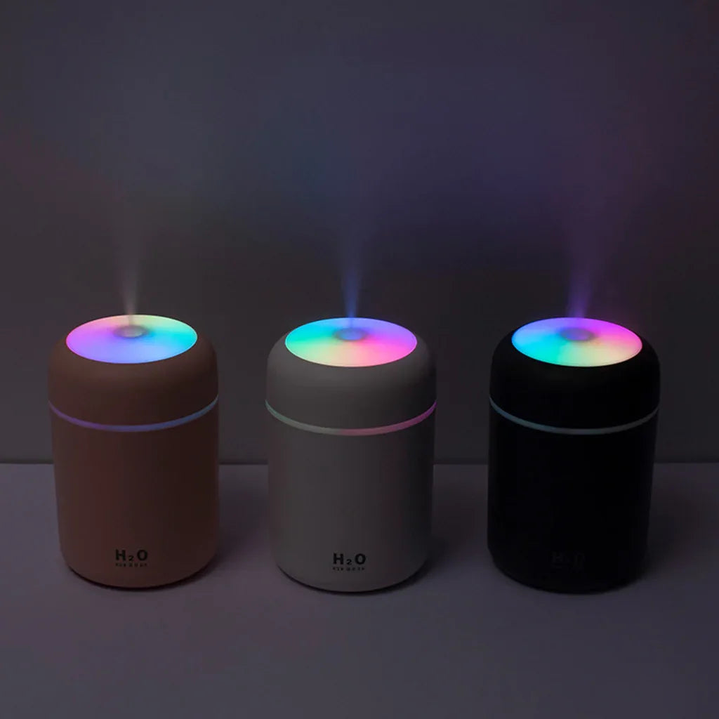 Close-up of portable aroma diffuser’s top showing mist release with soft ambient lighting.