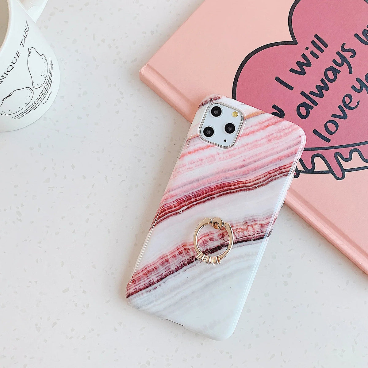Side view of marble iPhone case showing soft raised edges for screen protection.