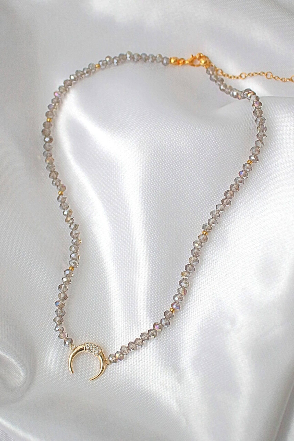 Light blue crystal choker necklace displayed on a white background showing its delicate design and shimmer.