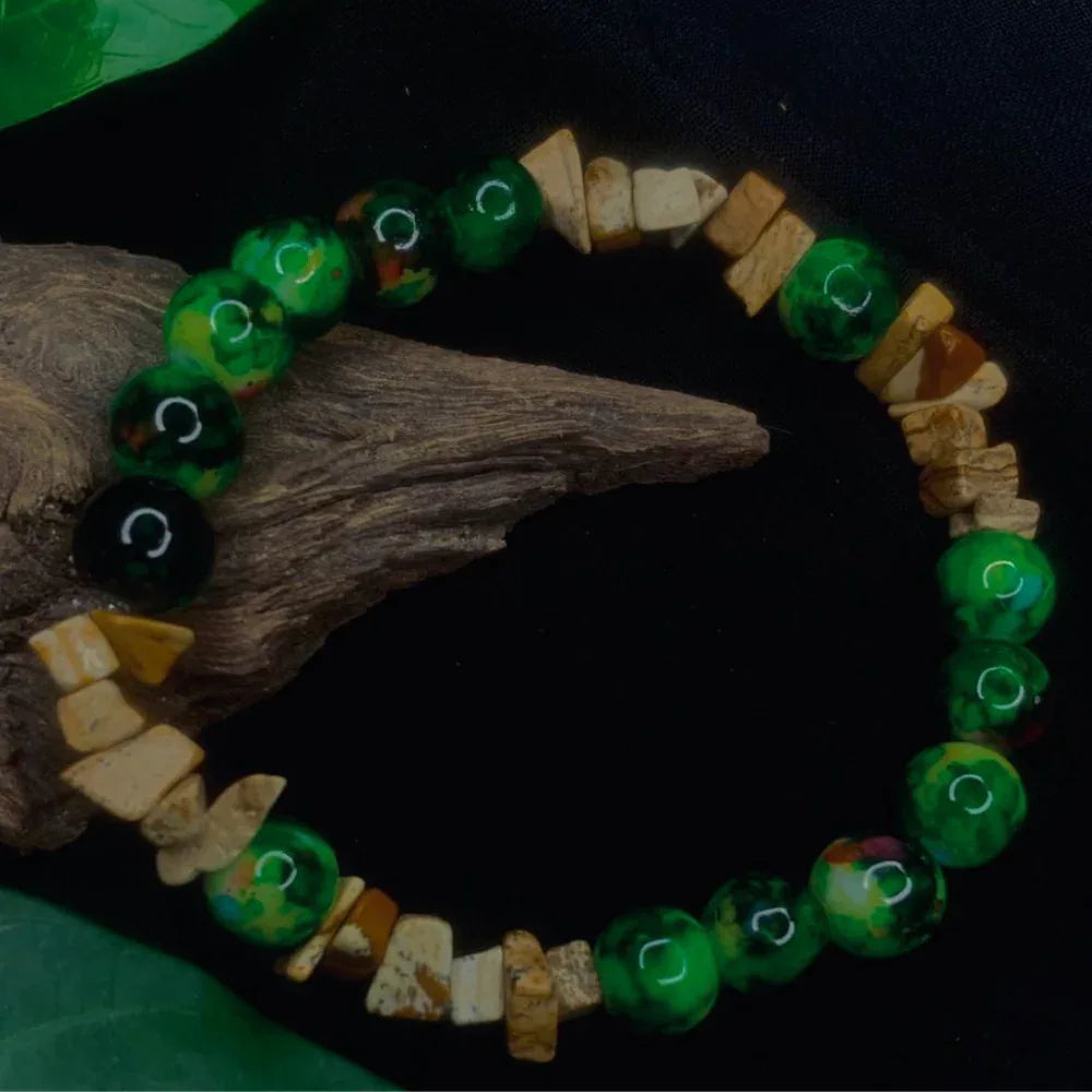 Top view of earthy Bark Agate and black-green bead chip stretch bracelet on white background.