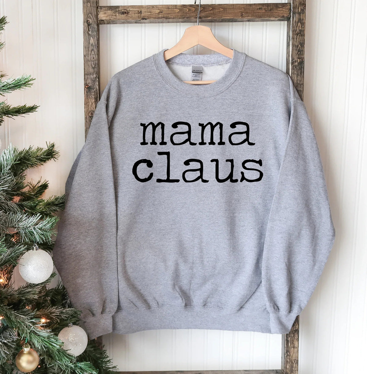 Front view of Mama Claus Christmas sweatshirt with festive holiday graphics on chest.