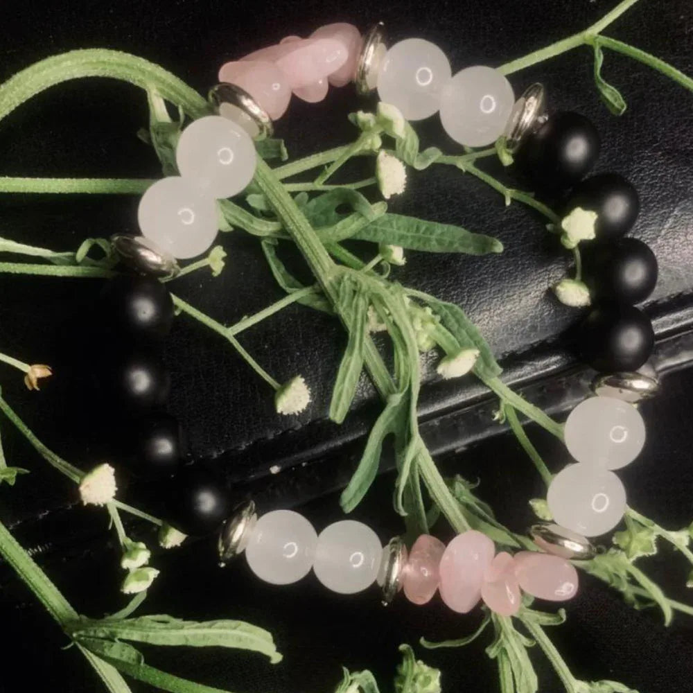 Bracelet composed of round black onyx, white jade beads, rose quartz chips, and silver-tone spacers