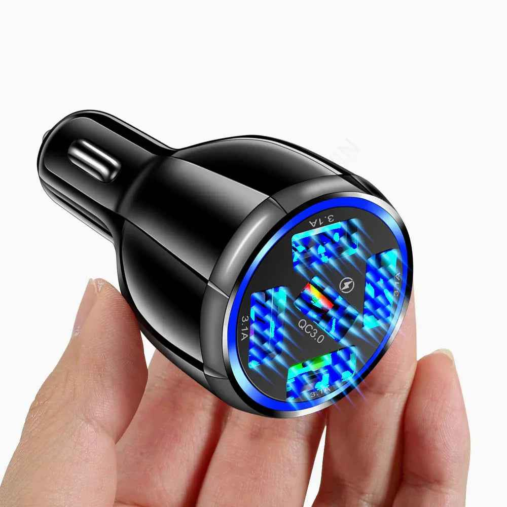 Black car charger with five USB ports plugged into a car, charging several devices at once.