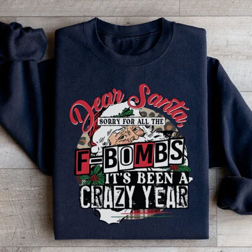 Close-up of black sweatshirt showing 'Dear Santa Sorry For All The F Bombs' text in white.