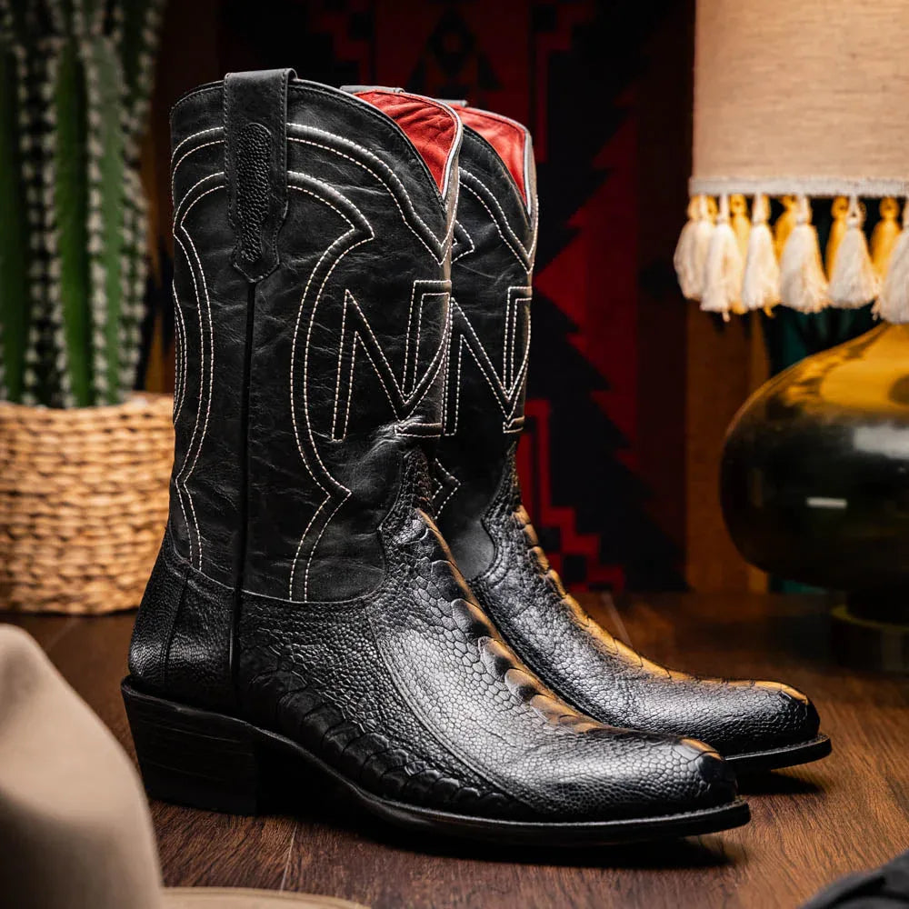 Model wearing Denver Black cowboy boots standing outdoors on wooden steps.