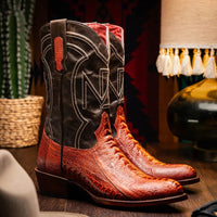 Model wearing Denver Rustic Cognac cowboy boots with jeans sitting on wooden steps outdoors.