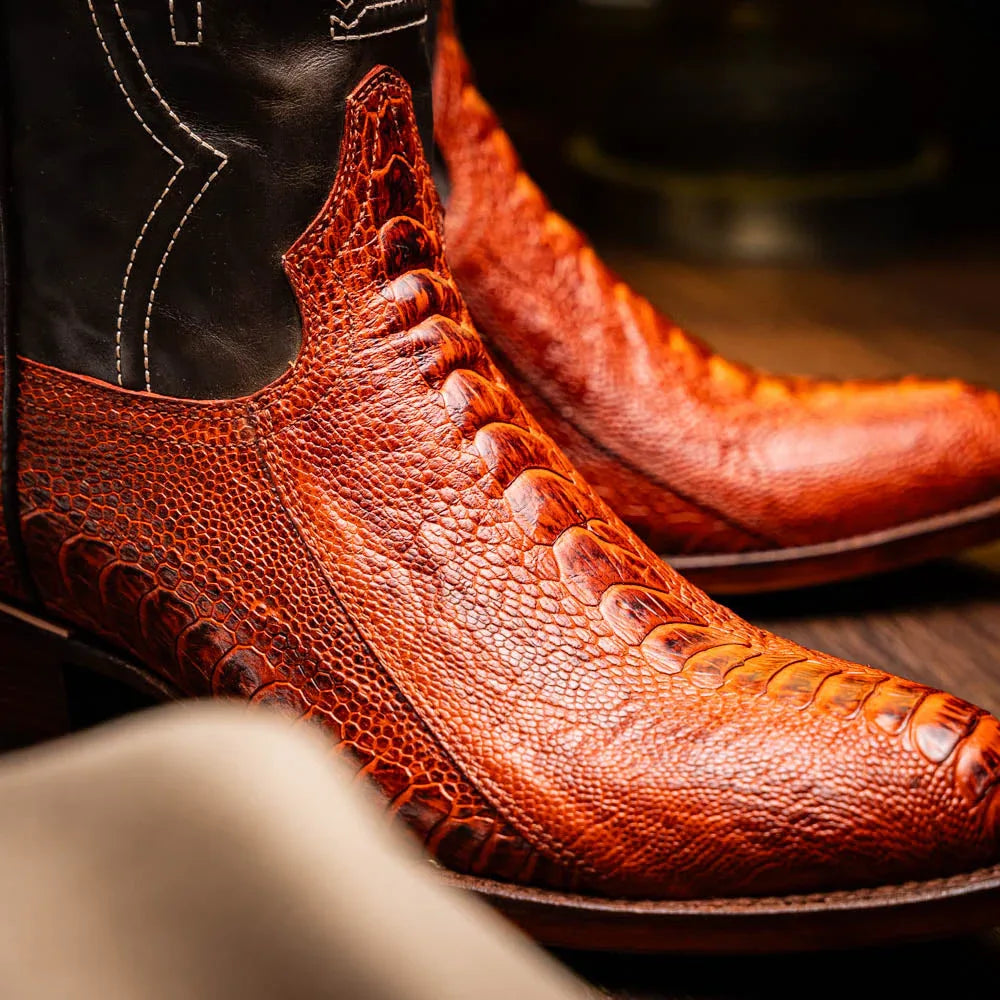 Side view of Denver Rustic Cognac boots worn with casual outfit on a wooden porch.