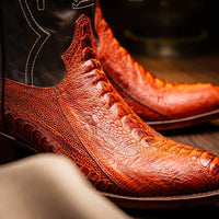 Side view of Denver Rustic Cognac boots worn with casual outfit on a wooden porch.