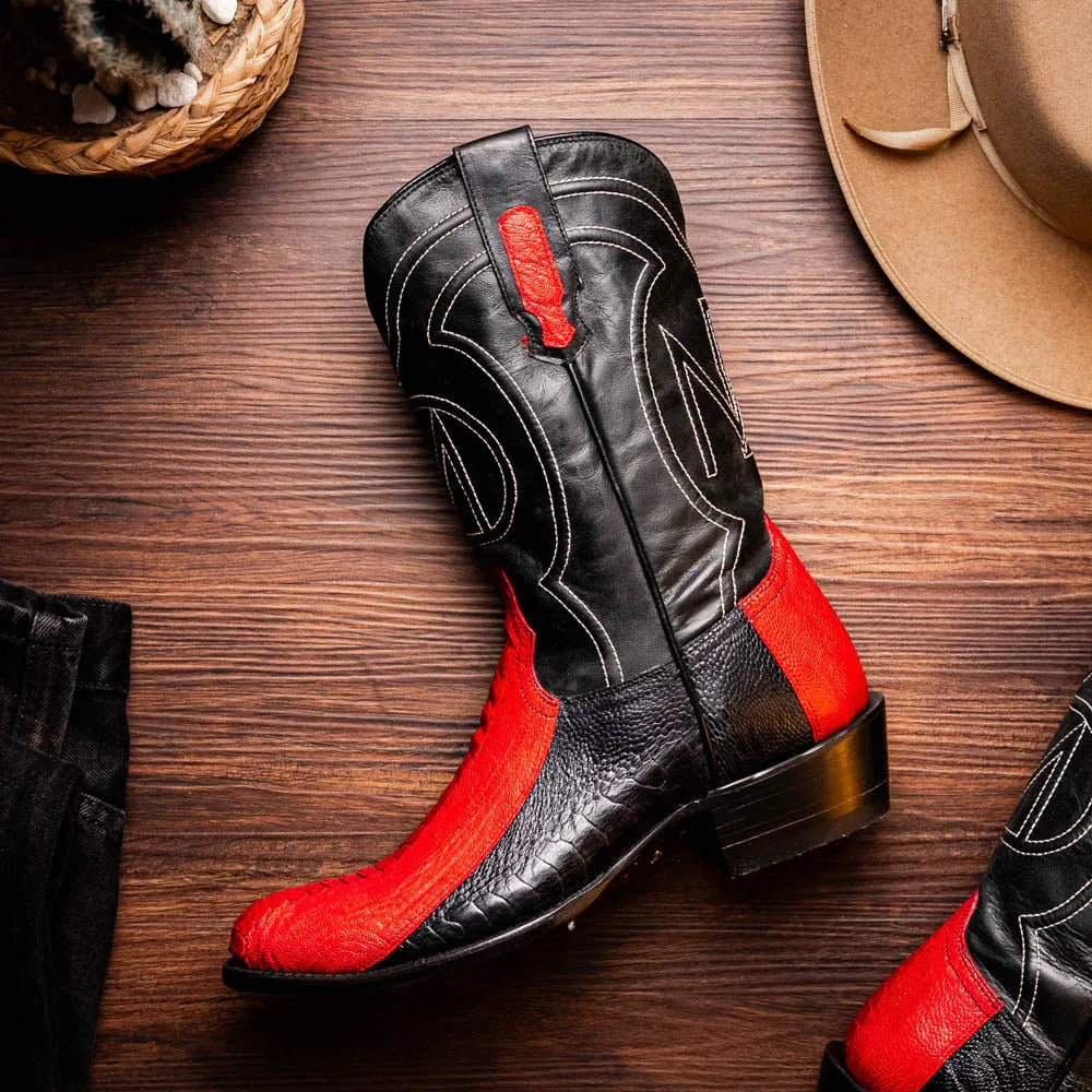 Lifestyle image of Denver red and black ostrich leg cowboy boots on feet.