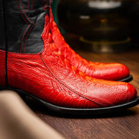 Lifestyle shot of Denver Red boots worn with jeans, featuring round toe and rich leather grain.