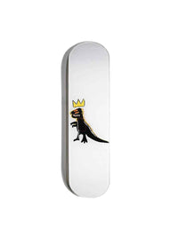 Skateboard with colorful dinosaur graphic laid on wooden floor