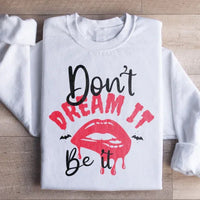 White sweatshirt with fleece lining and 'Don't Dream It' text, warm and cozy design.