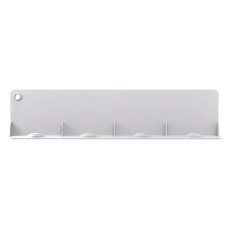 Top view of flexible silicone water baffle covering kitchen sink drain to prevent splashing.