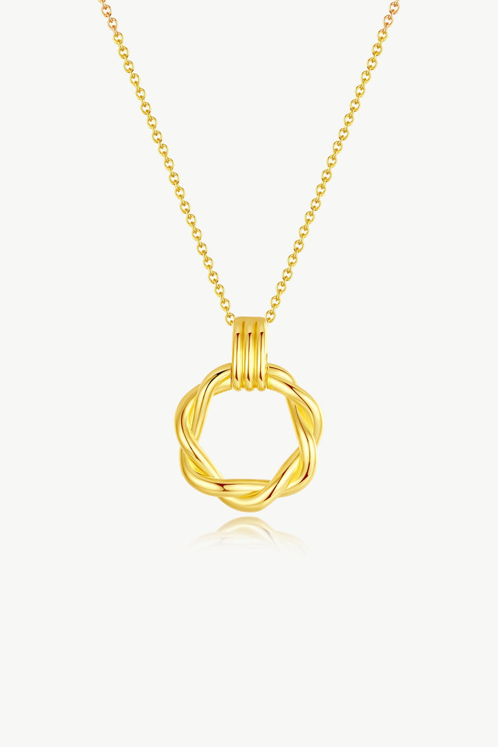 Close-up of Eléa Gold Twisted Hoop Pendant Necklace showing intricate twisted design against neutral background.