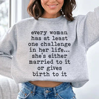 Sport grey sweatshirt with white bold text 'Every Woman Has At Least One Challenge In Life' on front.