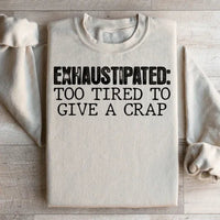 Sand-colored sweatshirt featuring peach text saying Exhaustipated To Tired To Give A Crap on front.